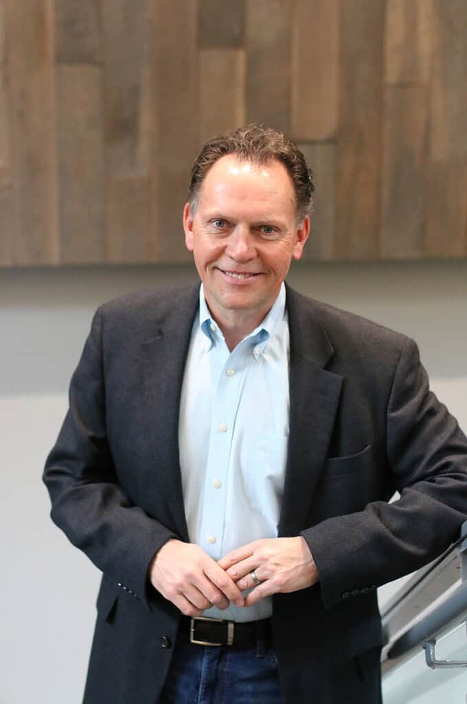 The Truth About You Book Review 2 Friendly professional man smiling in a business suit indoors.